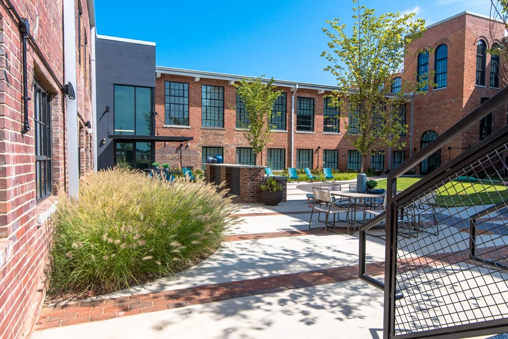 our apartments offer a spacious courtyard with tables and chairs