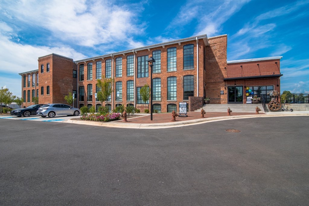 a large brick building with cars parked in front of it