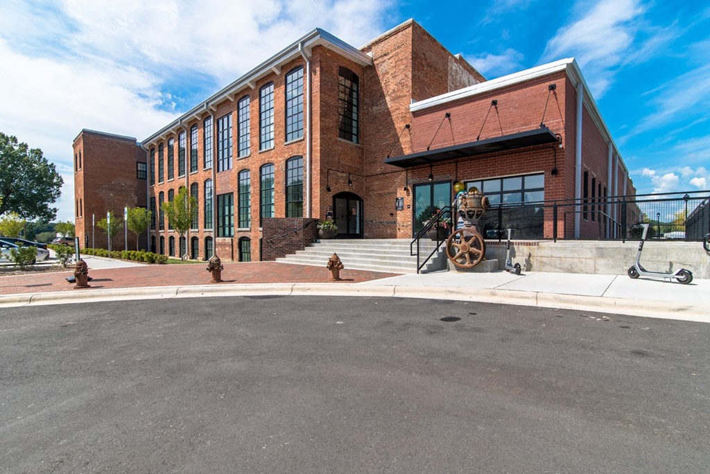the front of a brick building with a fire hydrant