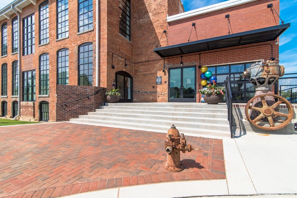the front of a brick building with a fire hydrant