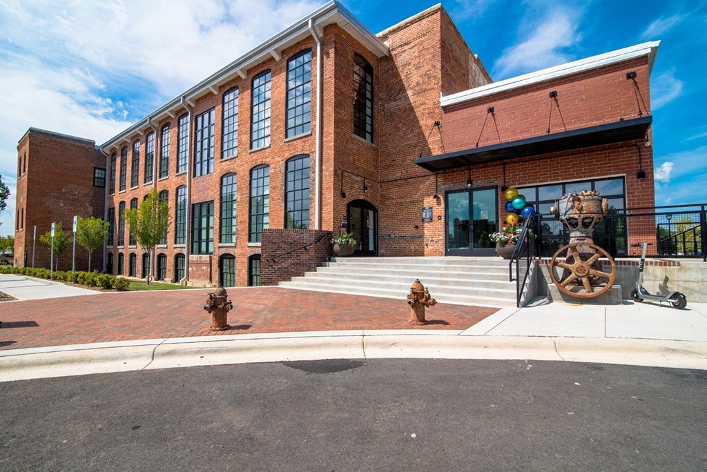 the front of a brick building with a cannon in front