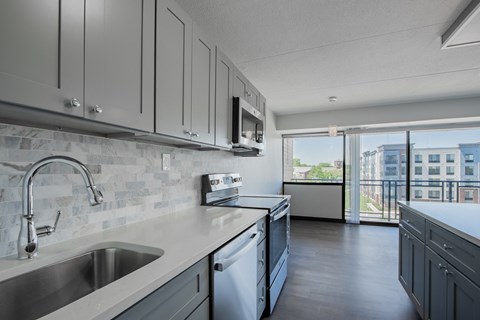 A modern kitchen with a stainless steel sink and dishwasher.