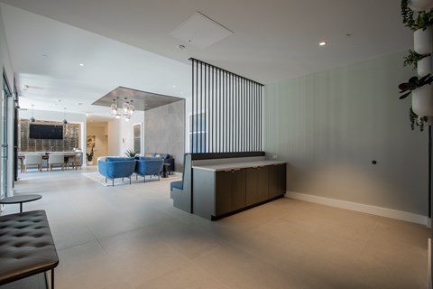 Lobby view at The Rail with seating and divider wall, highlighting design-forward amenity space in this luxury pet-friendly apartment community.