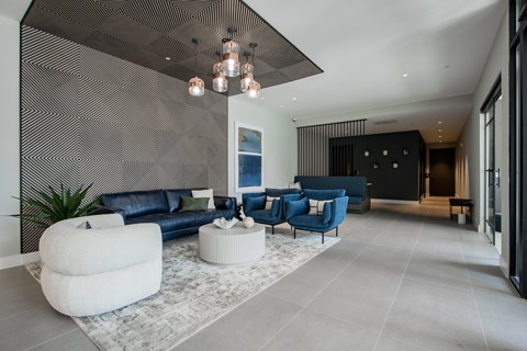 Lobby view at The Rail with seating and divider wall, highlighting design-forward amenity space in this luxury pet-friendly apartment community.