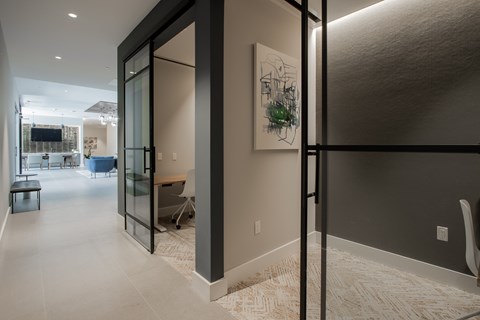 Quiet work nook with glass doors and modern lighting at The Rail at Bound Brook in Bound Brook, NJ.