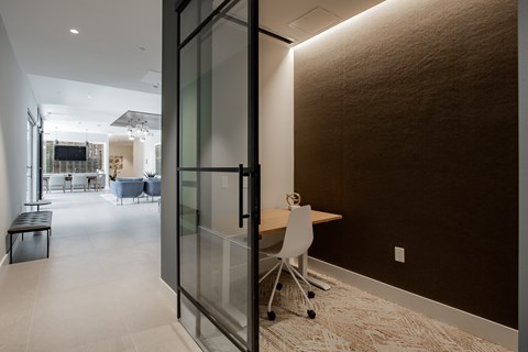 Quiet work nook with glass doors and modern lighting at The Rail at Bound Brook in Bound Brook, NJ.