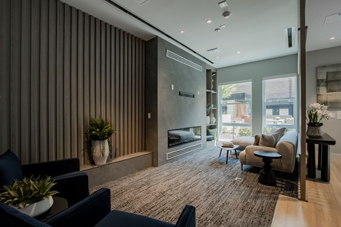 Cozy lounge space in The Rail's game room with fireplace and soft seating.