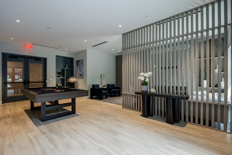 Luxury apartment game room at The Rail in Bound Brook, NJ, with pool table, seating area, and stylish décor designed for relaxation and entertainment.