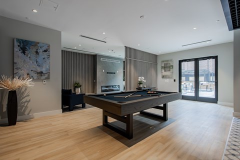 Sophisticated clubroom at The Rail at Bound Brook with billiards, modern furniture, and built-in fireplace.