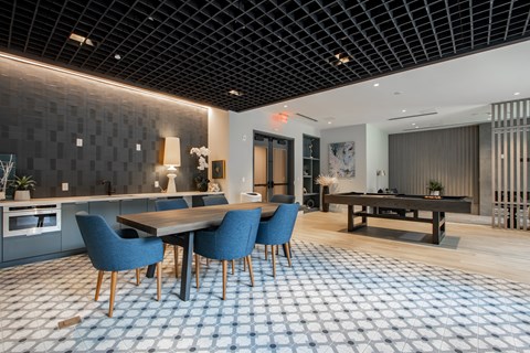 Game and lounge area at The Rail featuring pool table, modern seating, and decorative accents in Bound Brook NJ.