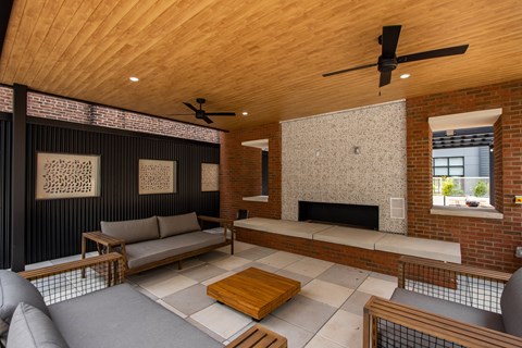 Covered outdoor fireplace lounge at The Rail at Bound Brook, offering cozy resident amenities in a modern Bound Brook apartment community.