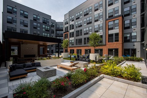 Scenic courtyard view at The Rail at Bound Brook with outdoor lounge areas, gardens, and modern architecture—luxury apartments in Bound Brook, NJ.