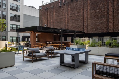 Outdoor lounge and ping pong table at The Rail at Bound Brook, a luxury apartment community in Downtown Bound Brook, NJ.