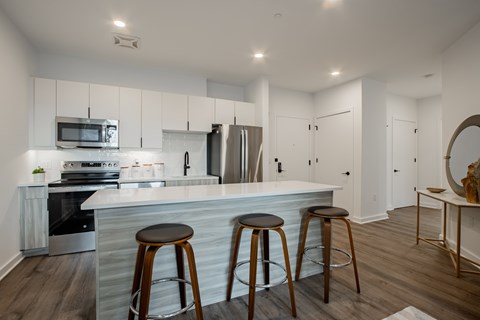 Spacious kitchen island and barstool seating in a luxury apartment at The Rail at Bound Brook, NJ.