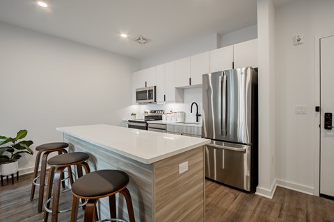 Luxury kitchen island and barstool seating in a luxury apartment at The Rail at Bound Brook, NJ.