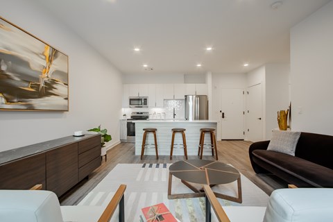 Luxury pet-friendly apartment living room with modern furnishings and natural light at The Rail at Bound Brook, NJ.
