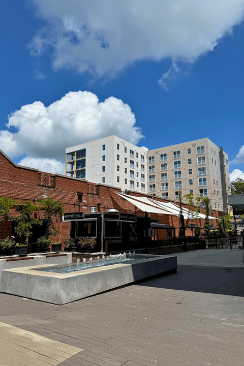 A modern building with a fountain in front of it.