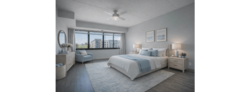 A well-lit bedroom with a large bed and a view of the city.