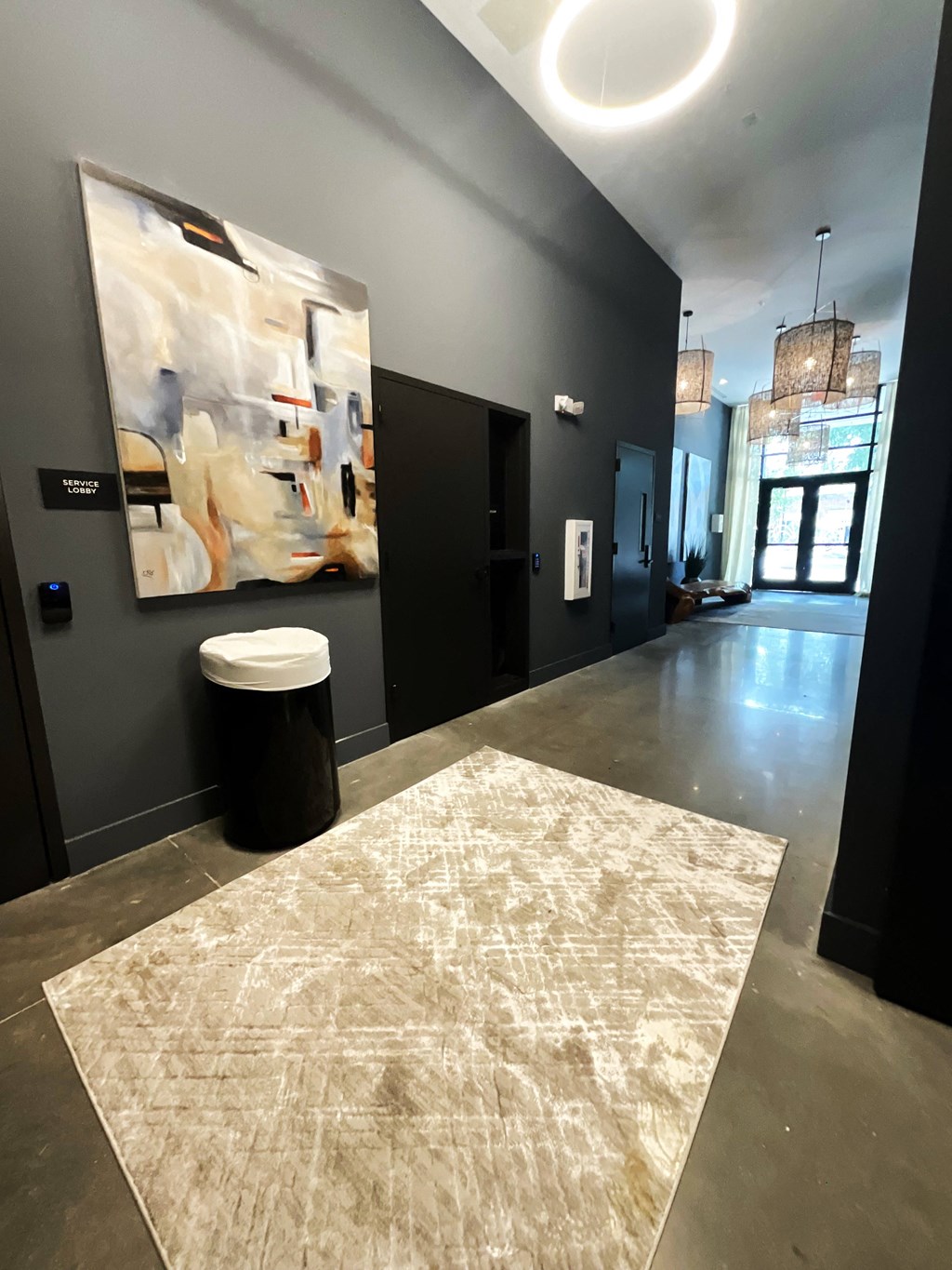 a hallway with a painting on the wall and a rug on the floor
