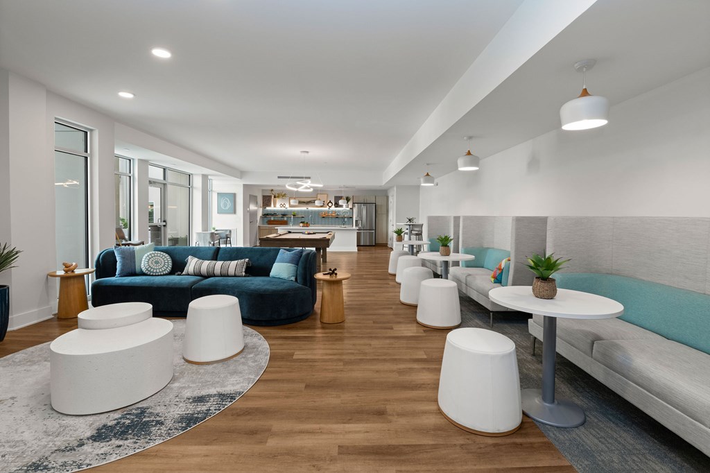 A modern living room with a long couch and a white coffee table.