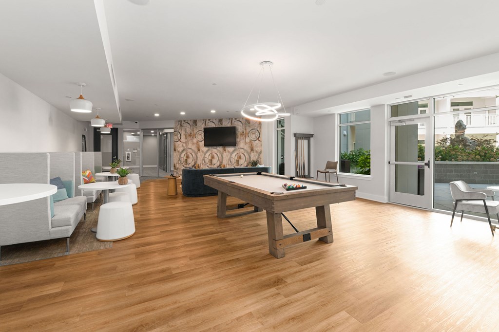A modern living room with a wooden floor and furniture.
