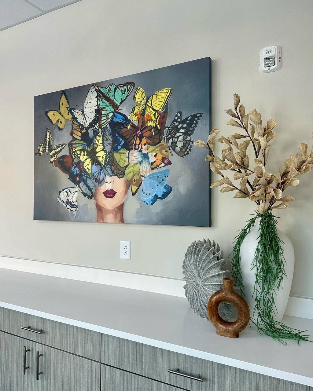 a painting of a woman with butterflies on a wall at Novi Rise, North Carolina