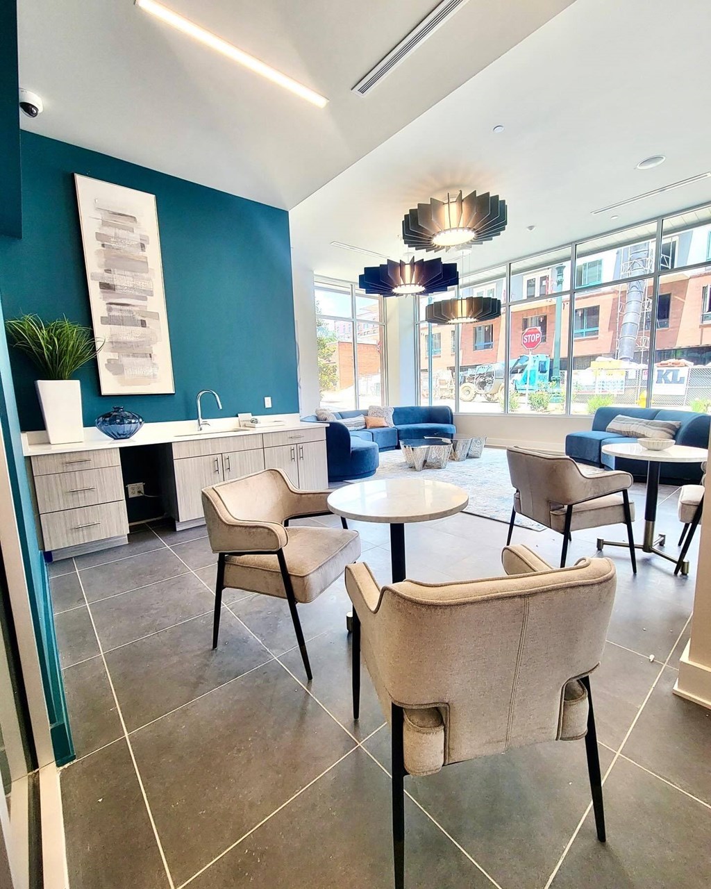 a seating area with chairs and tables in a lobby at Novi Rise, North Carolina