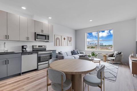 A modern kitchen with a dining table and chairs.