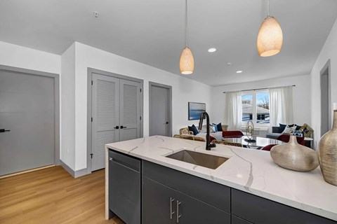 A kitchen with a sink and a counter.