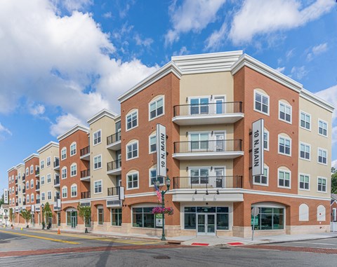 A large apartment building with a balcony on the second floor.