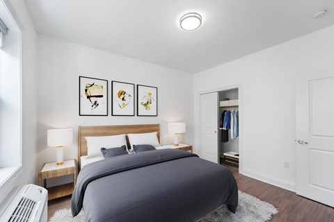 A bedroom with a large bed and a nightstand with a lamp.