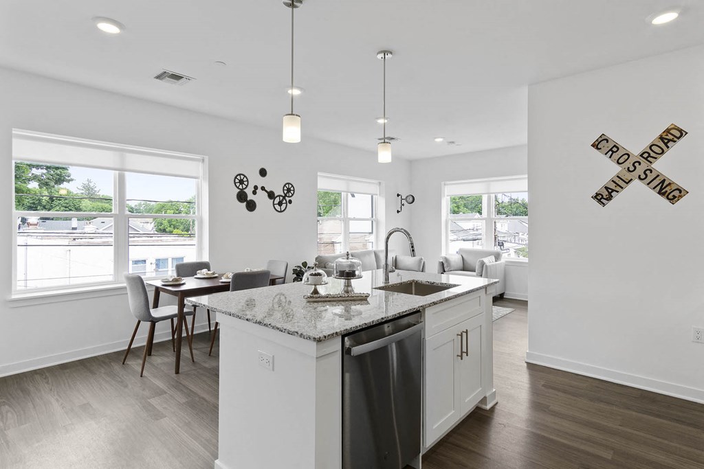 A kitchen with a granite counter top and a sink at 10 N. Main Apartments, Wharton 07885