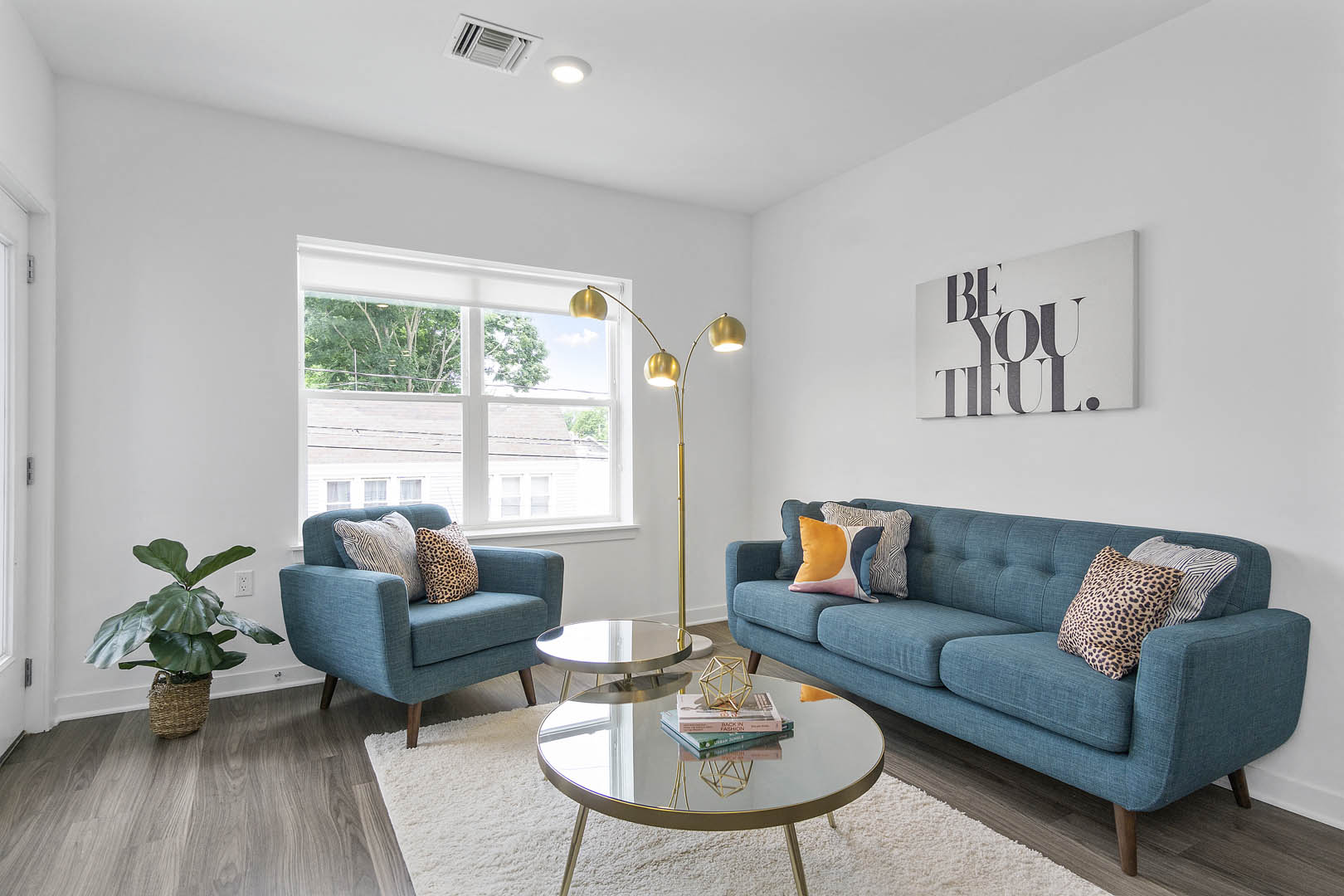 A living room with a blue couch and a coffee table.