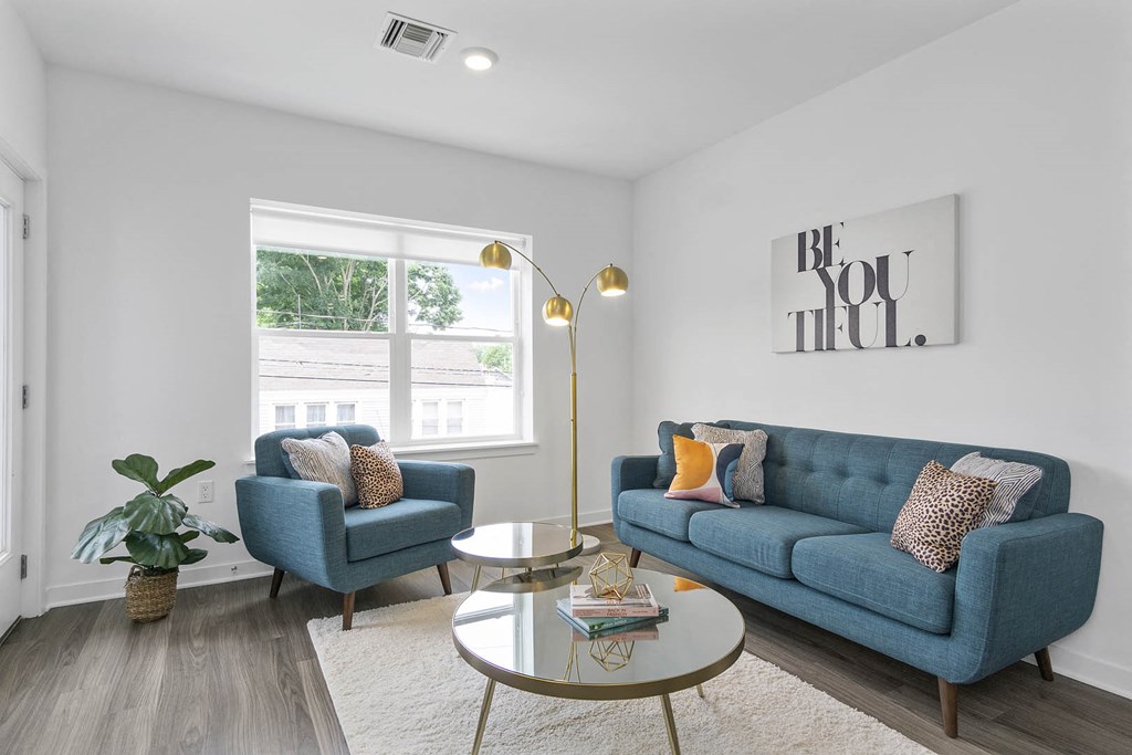 A living room with a blue couch and a coffee table.
