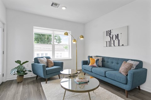 A living room with a blue couch and a coffee table.