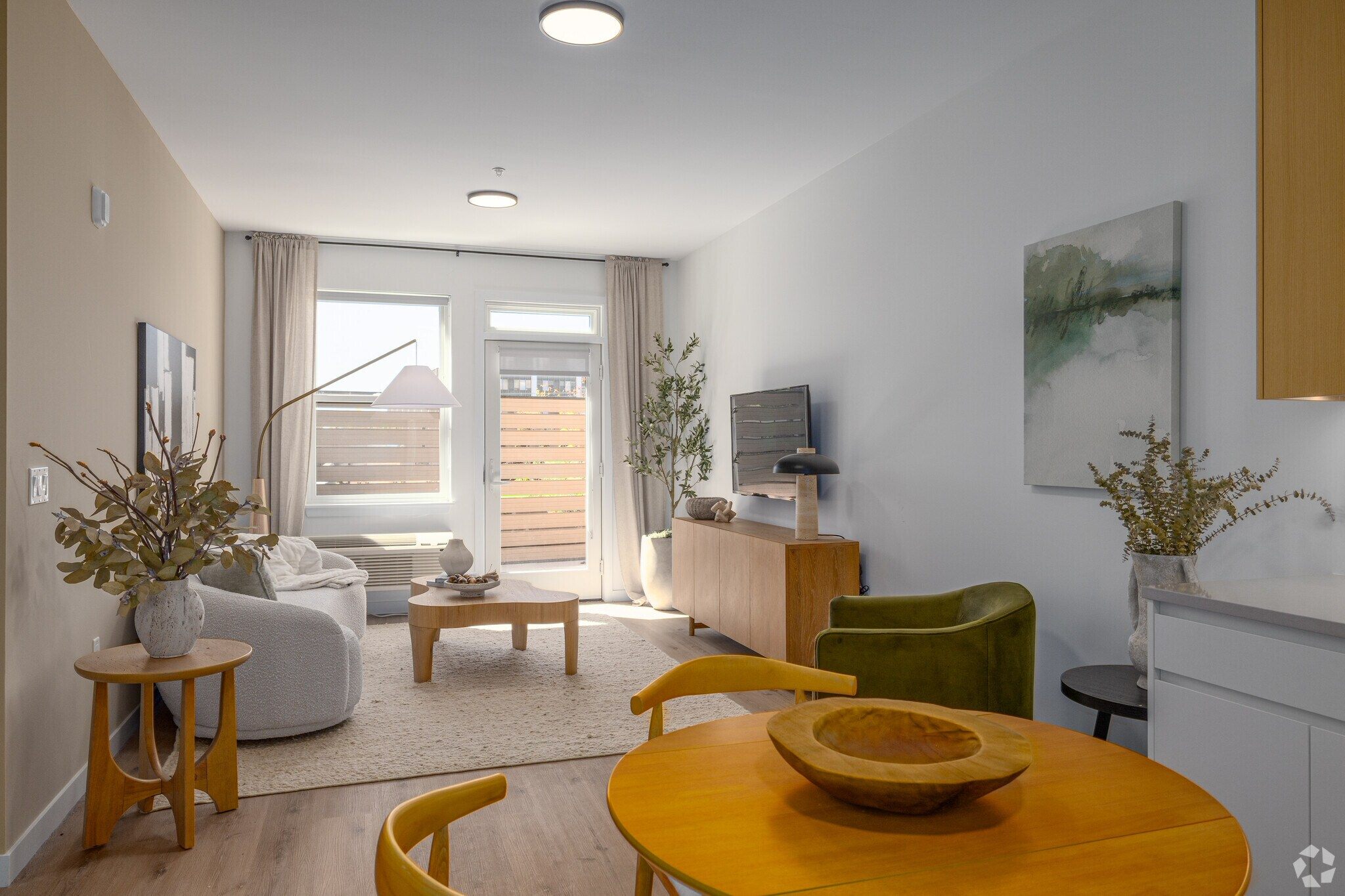 A living room with a yellow table and a green chair.