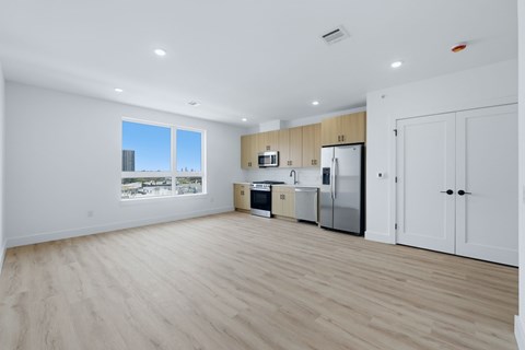 A kitchen with wooden floors and white walls.