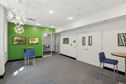 A room with a green wall and a white ceiling.
