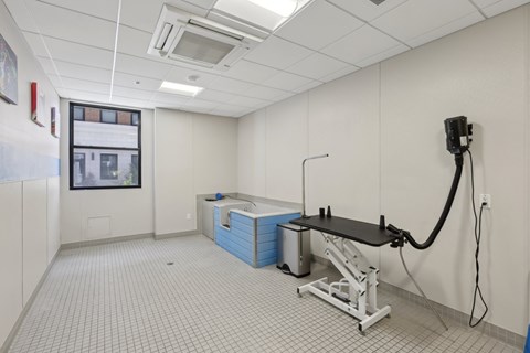 A room with a tiled floor and a table with a black top.