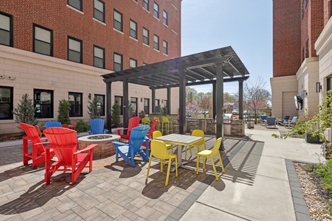 A patio with a table and chairs under a roof.