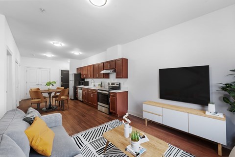 A modern living room with a grey sofa and a black television.
