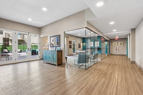 A spacious room with wooden floors and glass walls.