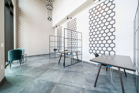 A dining room with a table and chairs.