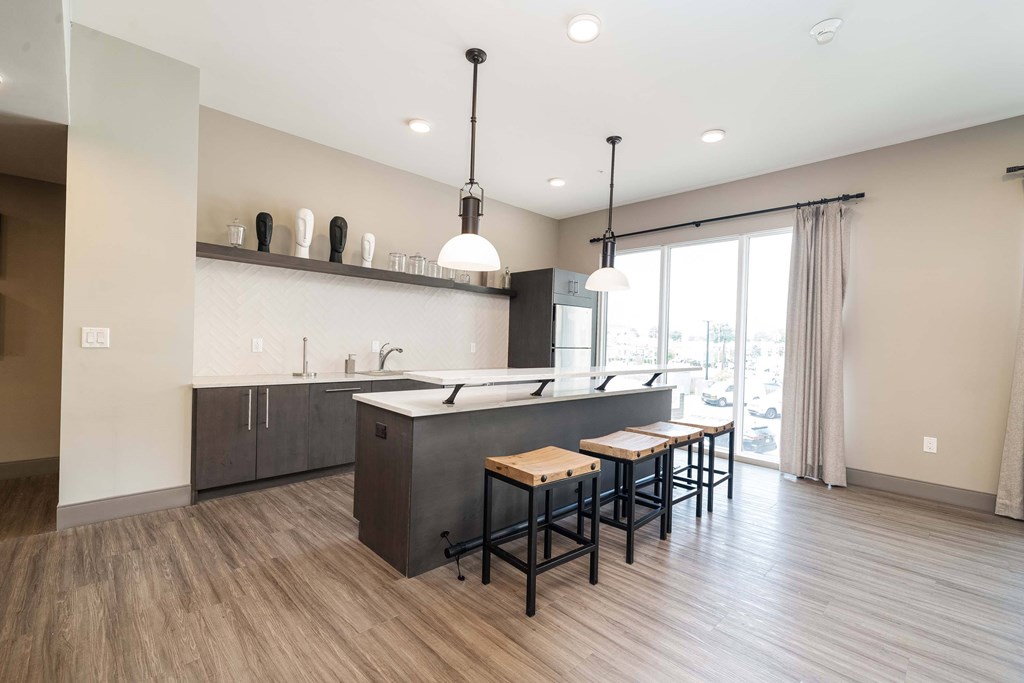 A modern kitchen with a large island and bar stools at Crossroads 389 Apartments, Hackensack, New Jersey
