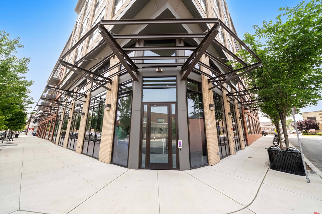 A building with a triangular facade and large glass windows at Crossroads 389 Apartments, Hackensack, NJ