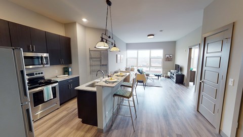 A kitchen with a dining table and chairs.