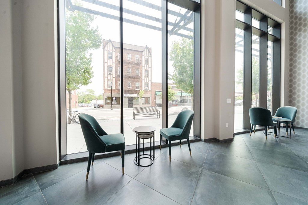 A room with a table and chairs in front of a large window at Crossroads 389 Apartments, Hackensack, New Jersey