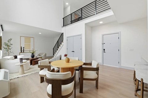 A modern living room with a wooden table and chairs.