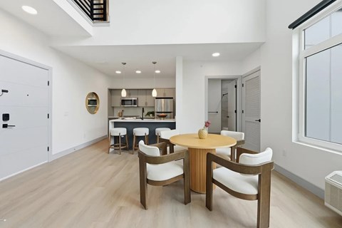 A modern dining room with a wooden table and chairs.