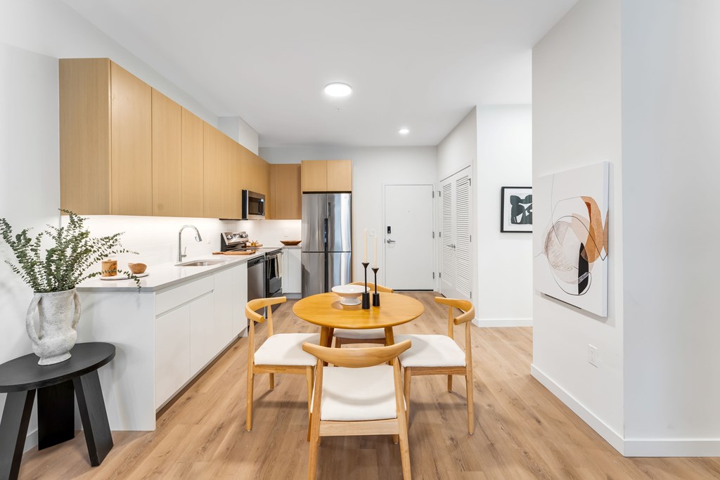 A Kitchen With Wooden Table and Chairs at Hue Soul Apartments, New Jersey, 07018